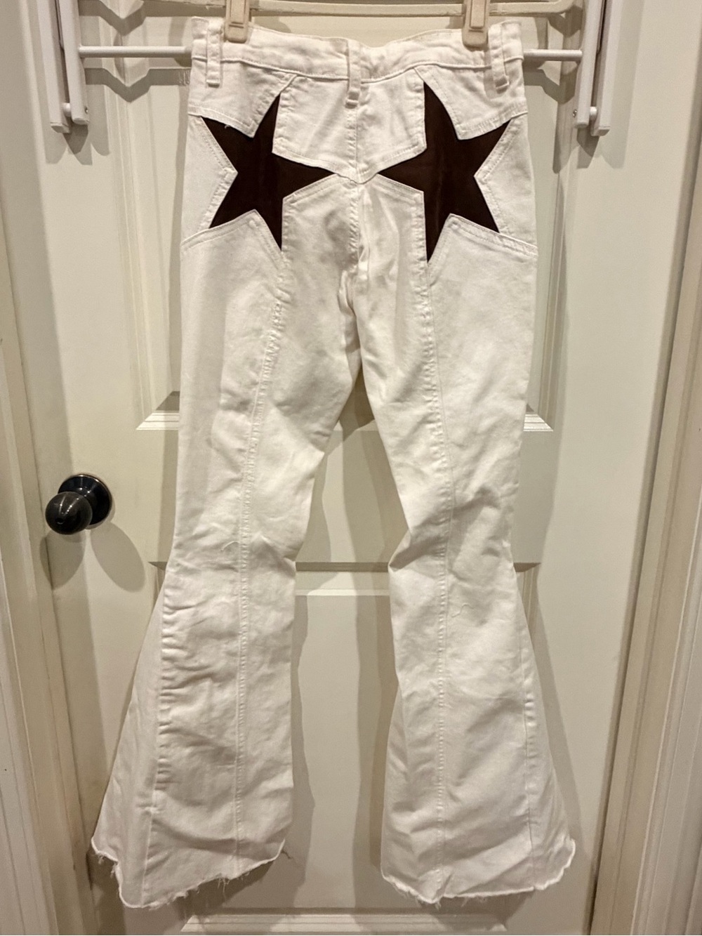 White Super Flared High-Waist Jeans with Suede Star Detail.